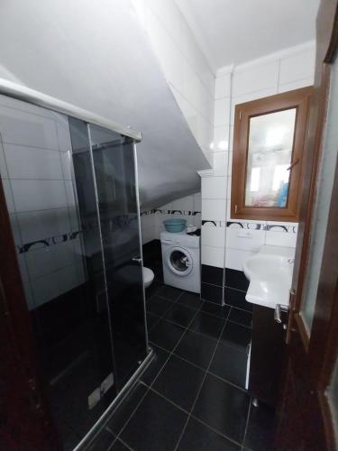 a bathroom with a shower and a sink and a toilet at Jasmin Apart Otel in Göcek