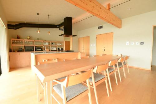 a large dining room with a long table and chairs at MOKU ISESHIMA ーl モク伊勢志摩 lー in Shima