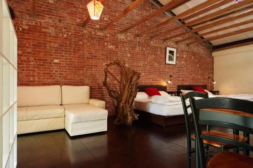 a brick room with a couch and a bed at Just For Fun B&B in Pingxi