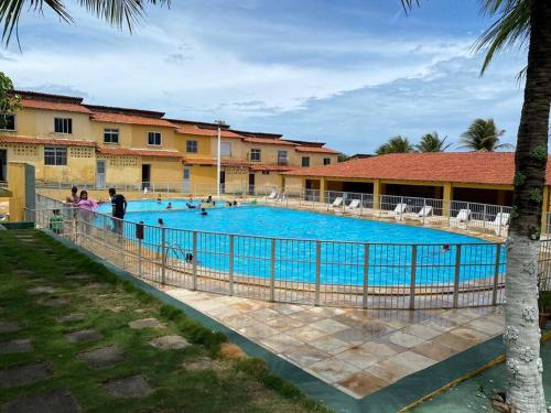 uma grande piscina com pessoas à sua volta em Sua casa na praia em Caucaia