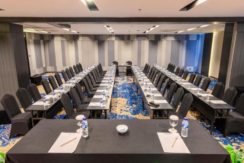 a conference room with long tables and chairs at Aston Sorong Hotel & Conference Center in Sorong