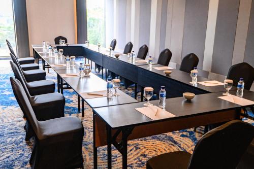 a long row of tables in a room with chairs at Aston Sorong Hotel & Conference Center in Sorong