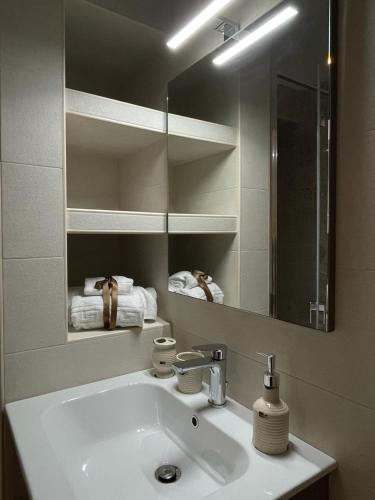 a bathroom with a sink and a mirror at A casa a Fasano in Fasano