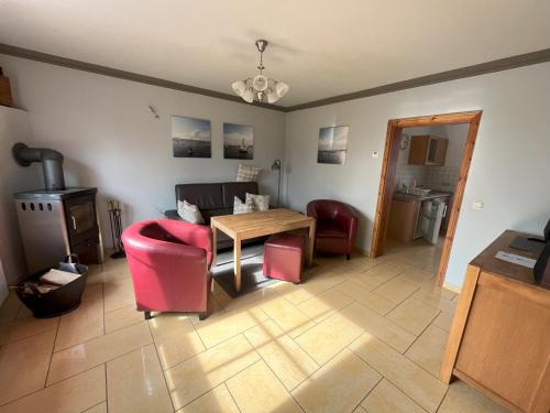 a living room with a couch and a table and chairs at Küstenferienhaus Nr. 91/92 in Stahlbrode