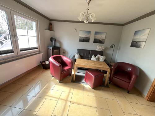 a living room with a table and two chairs at Küstenferienhaus Nr. 91/92 in Stahlbrode