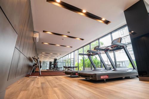a gym with a treadmill and elliptical machines at Aston Sorong Hotel & Conference Center in Sorong