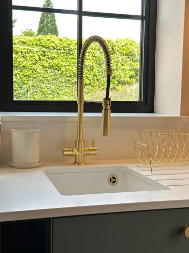 a sink in a kitchen with a window at The Annexe in Stockport