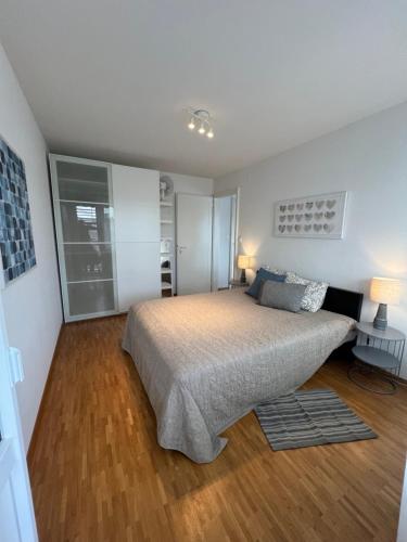 a bedroom with a bed and a wooden floor at High standing apartment in Ouchy - Lausanne in Lausanne