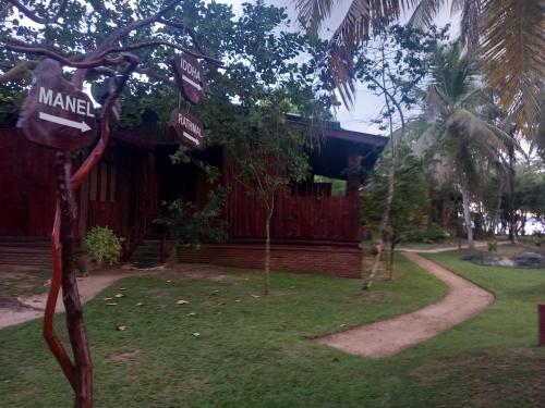 a street sign in front of a house at Lake Resort Bolgoda in Wadduwa