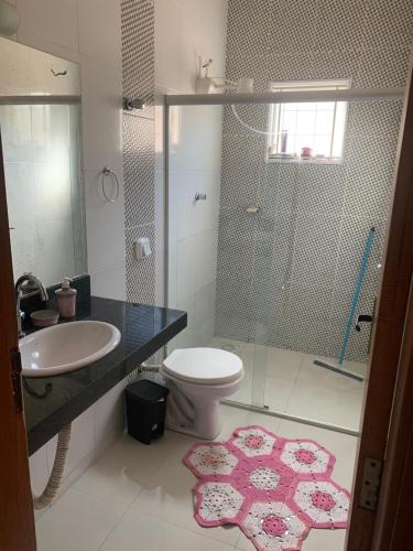 a bathroom with a sink and a toilet and a shower at Casa in Araxá