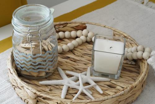 a basket with a jar and a cell phone in it at L'infini Sea View apartments Zubovići in Zubovići
