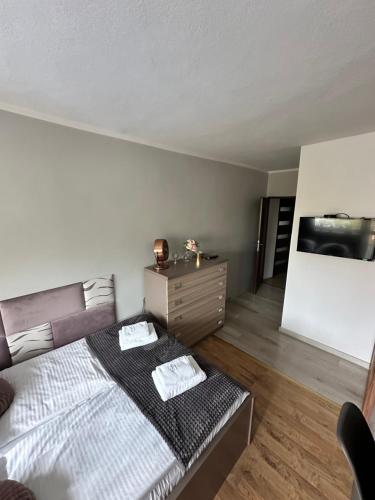 a bedroom with a bed and a dresser in it at Pokoje Gościnne in Kołobrzeg