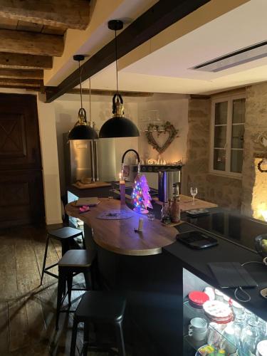 a kitchen with a island with a christmas tree on it at Gîte de charme avec spa sous les étoiles Corrèze in La Roche-Canillac