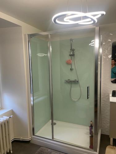 a shower with a glass door in a bathroom at Gîte de charme avec spa sous les étoiles Corrèze in La Roche-Canillac