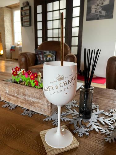 a wine glass with a stick in it on a table at Gîte de charme avec spa sous les étoiles Corrèze in La Roche-Canillac
