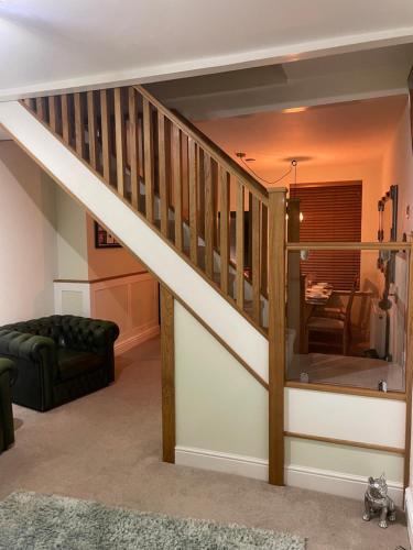 a staircase in a living room with a couch and a table at Impeccable 3-Bed House in York in York