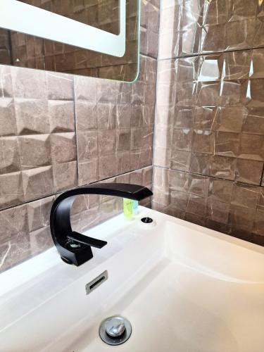 a bathroom sink with a black faucet on it at Beaver 2 HuntersMoon-Warminster-Bath-Salisbury in Warminster
