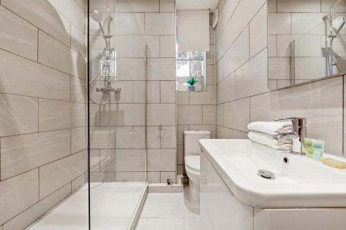 a bathroom with a shower and a sink and a toilet at The Grosvenor Residences in London