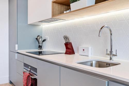 a kitchen with a sink and a counter top at Roomspace Serviced Apartments- Syward Place in Chertsey