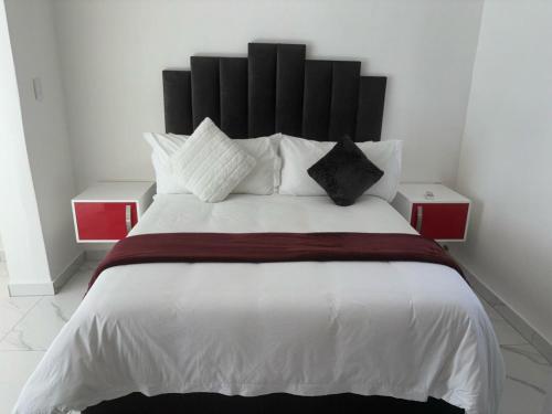 Ένα ή περισσότερα κρεβάτια σε δωμάτιο στο Le Rubis Guesthouse