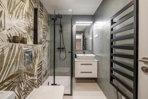 a bathroom with a shower and a toilet and a sink at MyFlat Wave Olive Apartment in Siófok