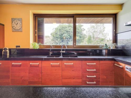 a kitchen with a sink and a large window at Xauxa in Sant Pere de Vilamajor