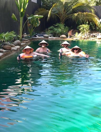 a group of people in the water wearing hats at Cóc Retreat Mỹ Tho City in My Tho