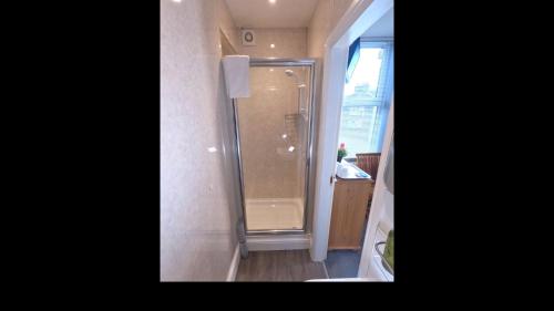 a bathroom with a shower with a glass door at Brook House ― Free on-site car park in Windermere