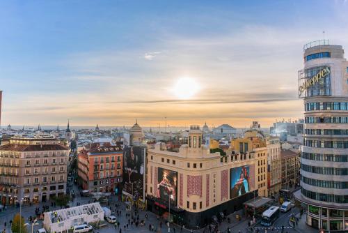 a view of a city at sunset at Hostal Josefina-Gran Vía in Madrid