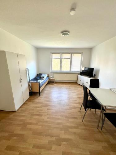 an empty room with a table and a bed at Große Monteurwohnung in Spremberg