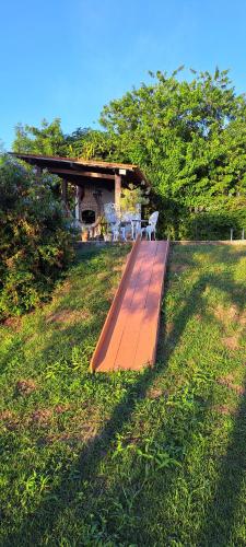 a wooden boardwalk in the middle of a field at Casa Schneider in Gravatá