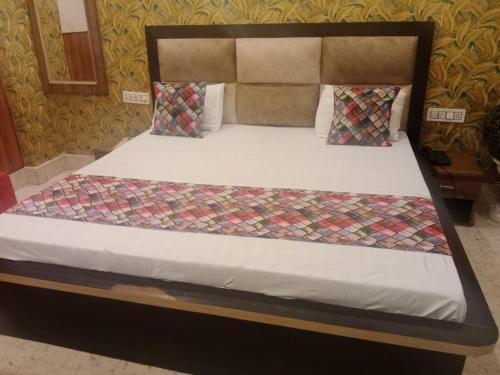 Bett in einem Zimmer mit einem großen Bett sidx sidx sidx sidx in der Unterkunft Hotel Aadhya & Resataurant in Auraiya