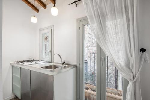 a kitchen with a sink and a window at Asso Residence Narni in Narni
