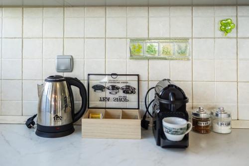 a kitchen counter with a tea kettle and other appliances at Verga Beachside Getaway with Panoramic Seaviews in Almirón