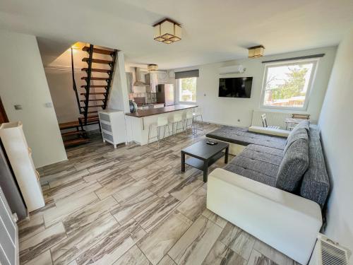 a living room with a couch and a kitchen at MIHI APARTMAN in Balatonvilágos