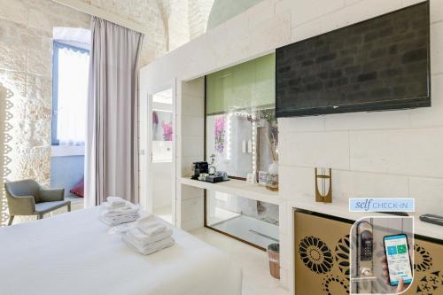 a hotel room with a bed and a fireplace at Vico Bianco Raro Smart Rooms Collection in Ostuni