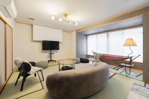 a living room with a large couch and a hammock at LINKAGE STAY HAKONE SENGOKUHARA in Hakone