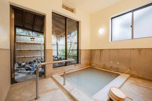 een badkamer met een toilet in een kamer met ramen bij LINKAGE STAY HAKONE SENGOKUHARA in Hakone