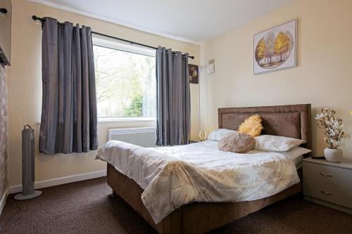 a bedroom with a bed and a large window at Sweet Dream Lodge in Manchester