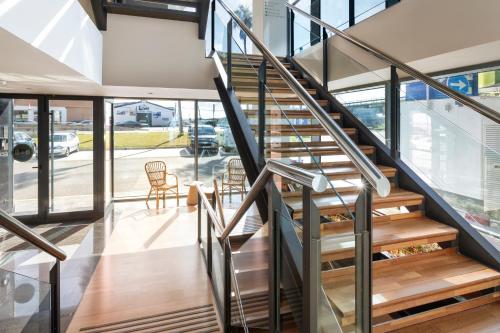a staircase in a house with glass walls at B&B HOTEL Écija in Écija