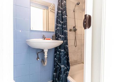 a bathroom with a sink and a shower at Vienna Getaway -2BR Apartment Central & Comfort in Vienna