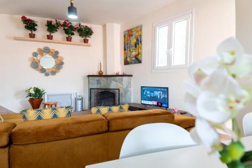 a living room with a couch and a fireplace at Hubstay - Hillside Home in Platres in Platres
