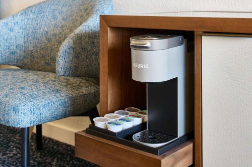 a hotel room with a coffee machine in a room at OUTRIGGER Kona Resort and Spa in Kailua-Kona