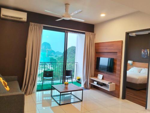 a living room with a bed and a tv at Lost World of Tambun, Sunway Onsen Studio, 1BR, 2-4pax in Tambun