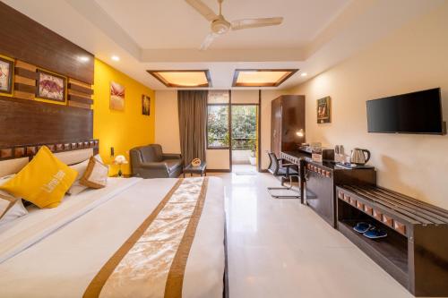 a hotel room with a bed and a flat screen tv at Lime Stays B&B GK-2 at Greater Kailash Metro South Delhi nearby Saket Select City in New Delhi