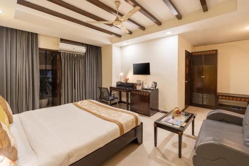a hotel room with a bed and a living room at Lime Stays B&B GK-2 at Greater Kailash Metro South Delhi nearby Saket Select City in New Delhi