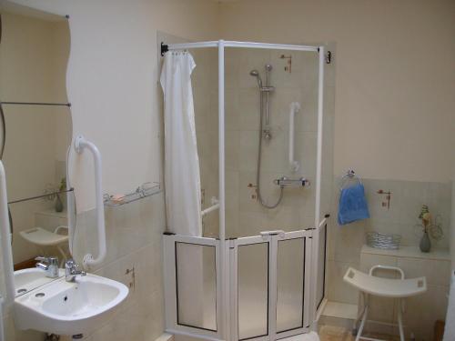 a bathroom with a shower and a sink at Knotts Farm Holiday Cottages in Lancaster