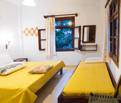 a room with two beds and a window at Villa Anna in Palaiochóra