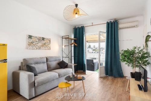 ein Wohnzimmer mit einem Sofa und einem Tisch in der Unterkunft Studio Californie FSHH in Nizza