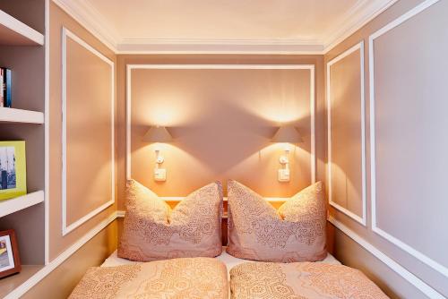 a bedroom with a bed with pillows on it at Eventschiff Grosser Michel in Hamburg